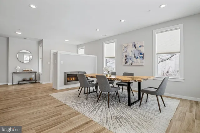 a view of a dining room with furniture and wooden floor