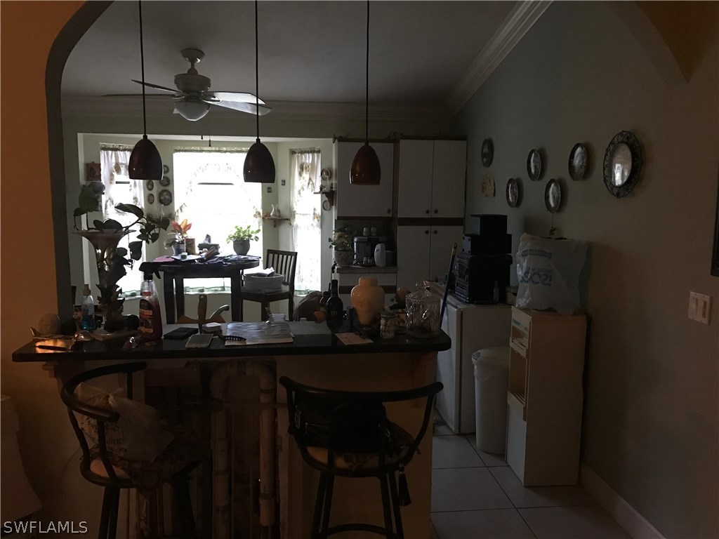 2590 54th Street Southwest Naples, FL 34116 - Photo 3 of 6 a kitchen with a table and chairs in it