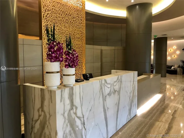 a bedroom with a bed and a potted plant