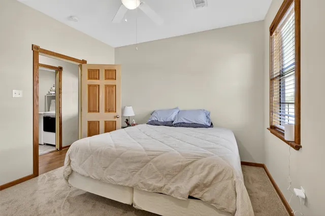 a large bed sitting in a bedroom next to a window