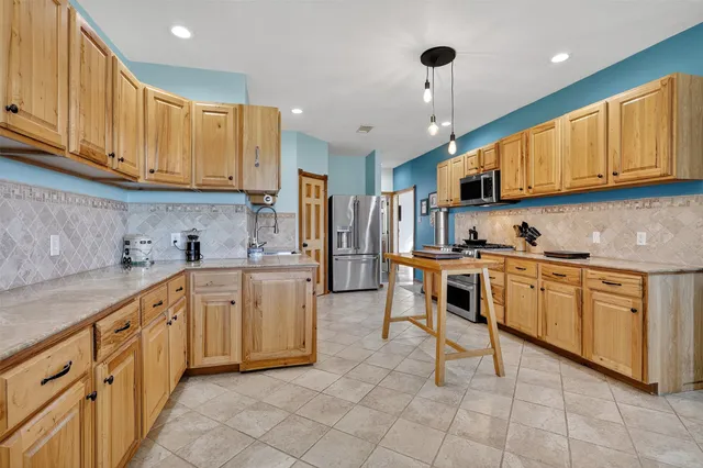 a kitchen with appliances cabinets and a sink