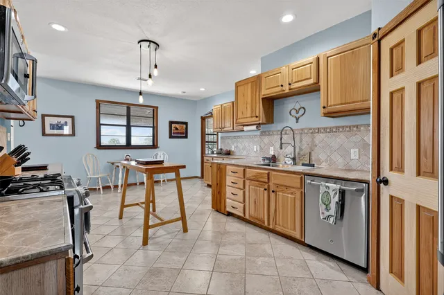 a kitchen with stainless steel appliances granite countertop a sink and cabinets