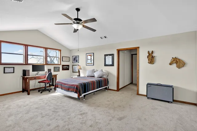 a spacious bedroom with a bed and a window