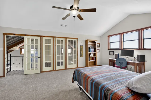 a spacious bedroom with a large bed and a large window