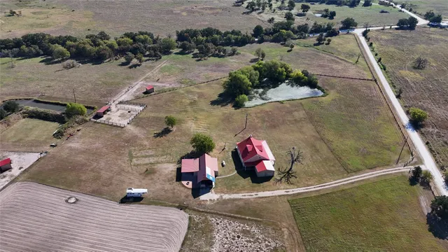 an aerial view of a house with a yard