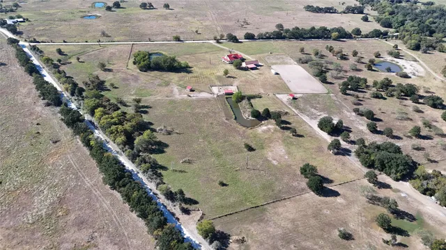 an aerial view of a house with a yard