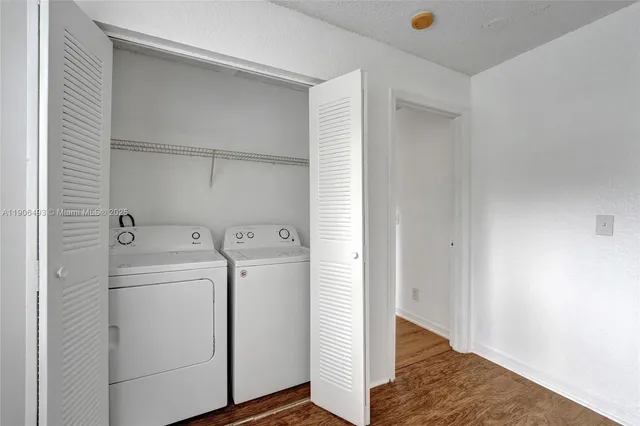a view of a room with wooden floor and a sink