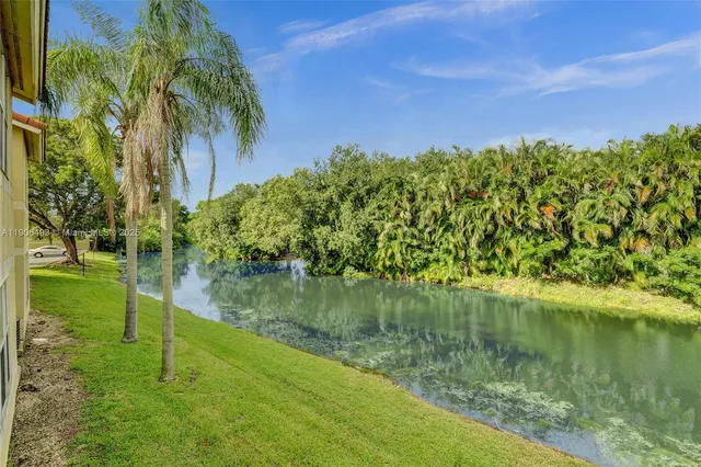 a view of a kitchen with a sink and a refrigerator