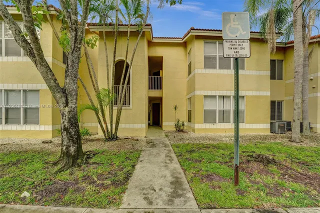 a view of a kitchen with a sink and a refrigerator