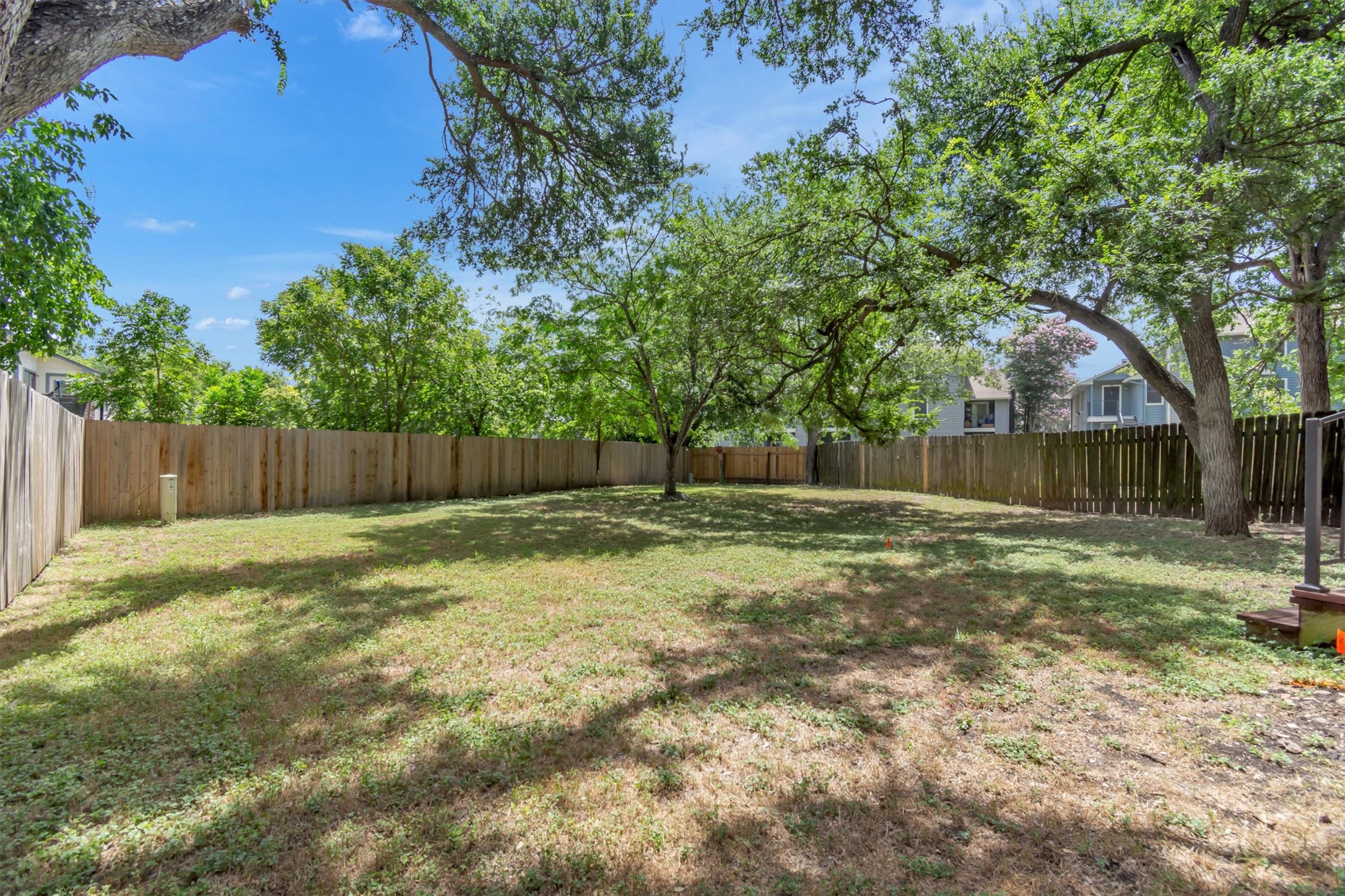 7802 Topawa Cove, Unit B Austin, TX 78729 - Photo 25 of 32 A spacious, fenced backyard offers abundant potential for outdoor living and recreation.