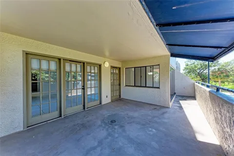 an empty room with wooden floor outdoor view and windows
