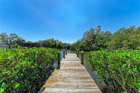 a sign that is sitting in front of flowers