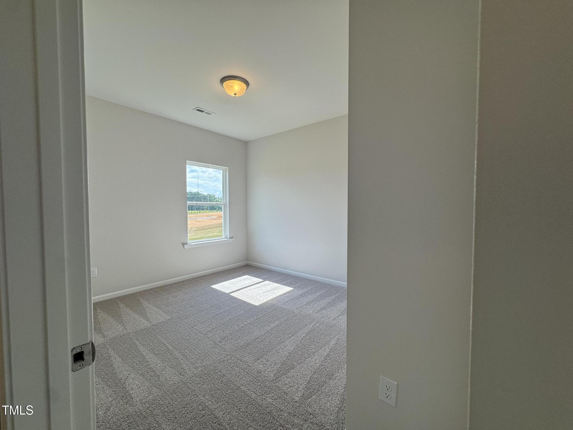 184 Bruce Drive Dunn, NC 28334 - Photo 16 of 32 a view of an empty room with a window