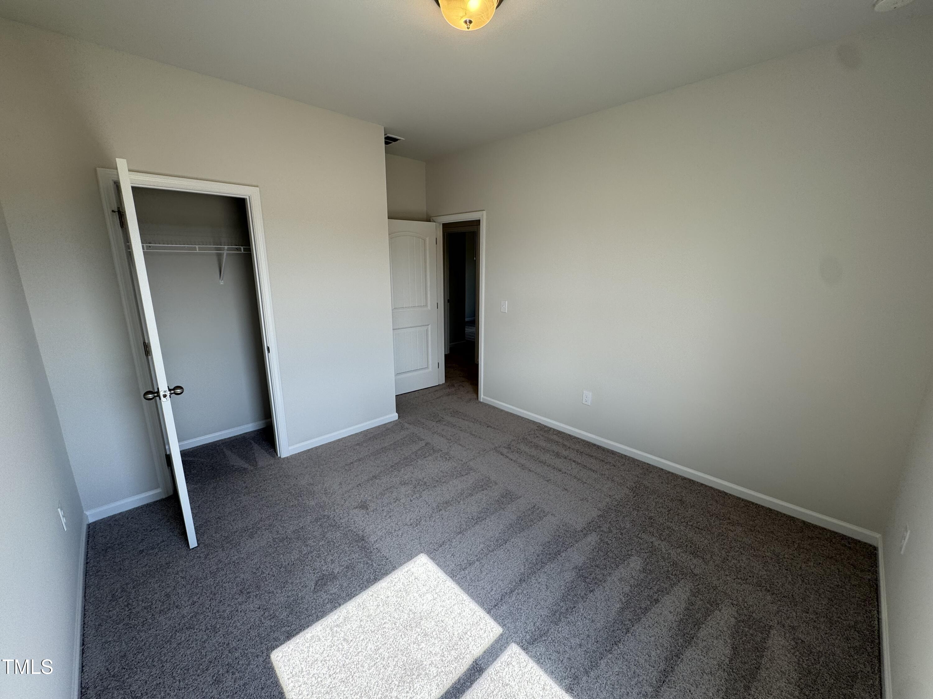 184 Bruce Drive Dunn, NC 28334 - Photo 17 of 32 an empty room with closet