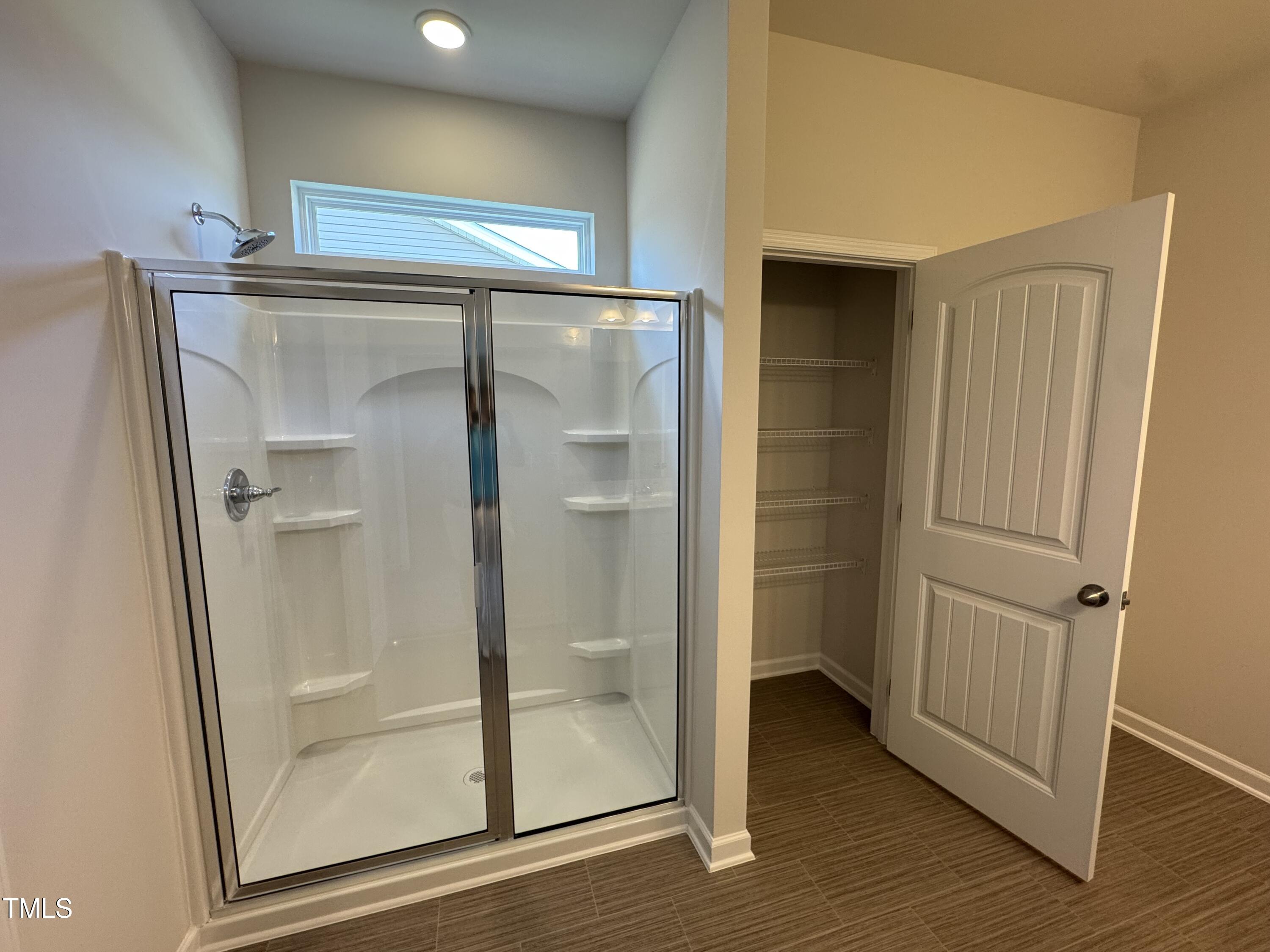184 Bruce Drive Dunn, NC 28334 - Photo 22 of 32 a bathroom with a glass shower door and a mirror
