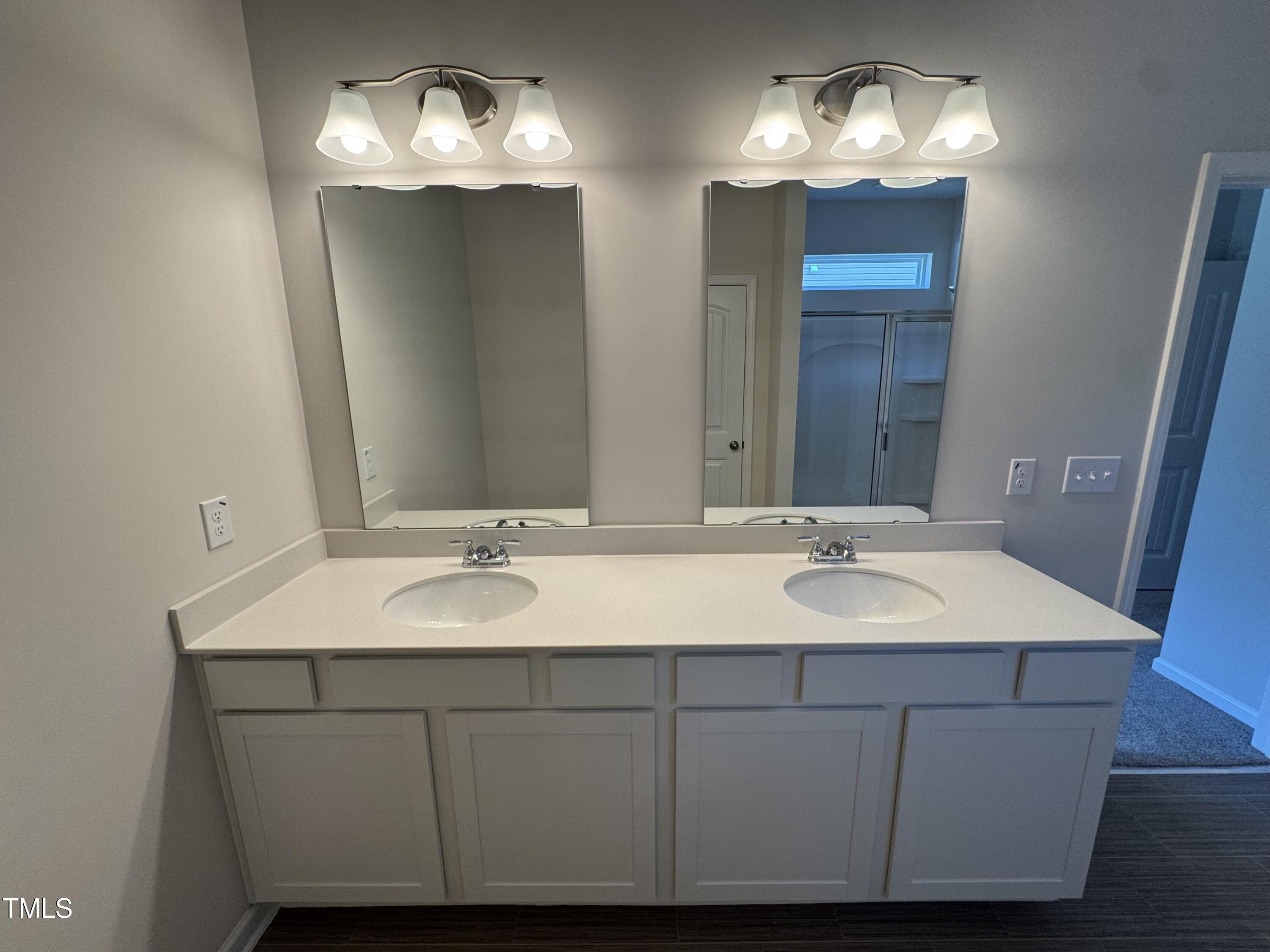 184 Bruce Drive Dunn, NC 28334 - Photo 23 of 32 a bathroom with a double vanity sink and a mirror