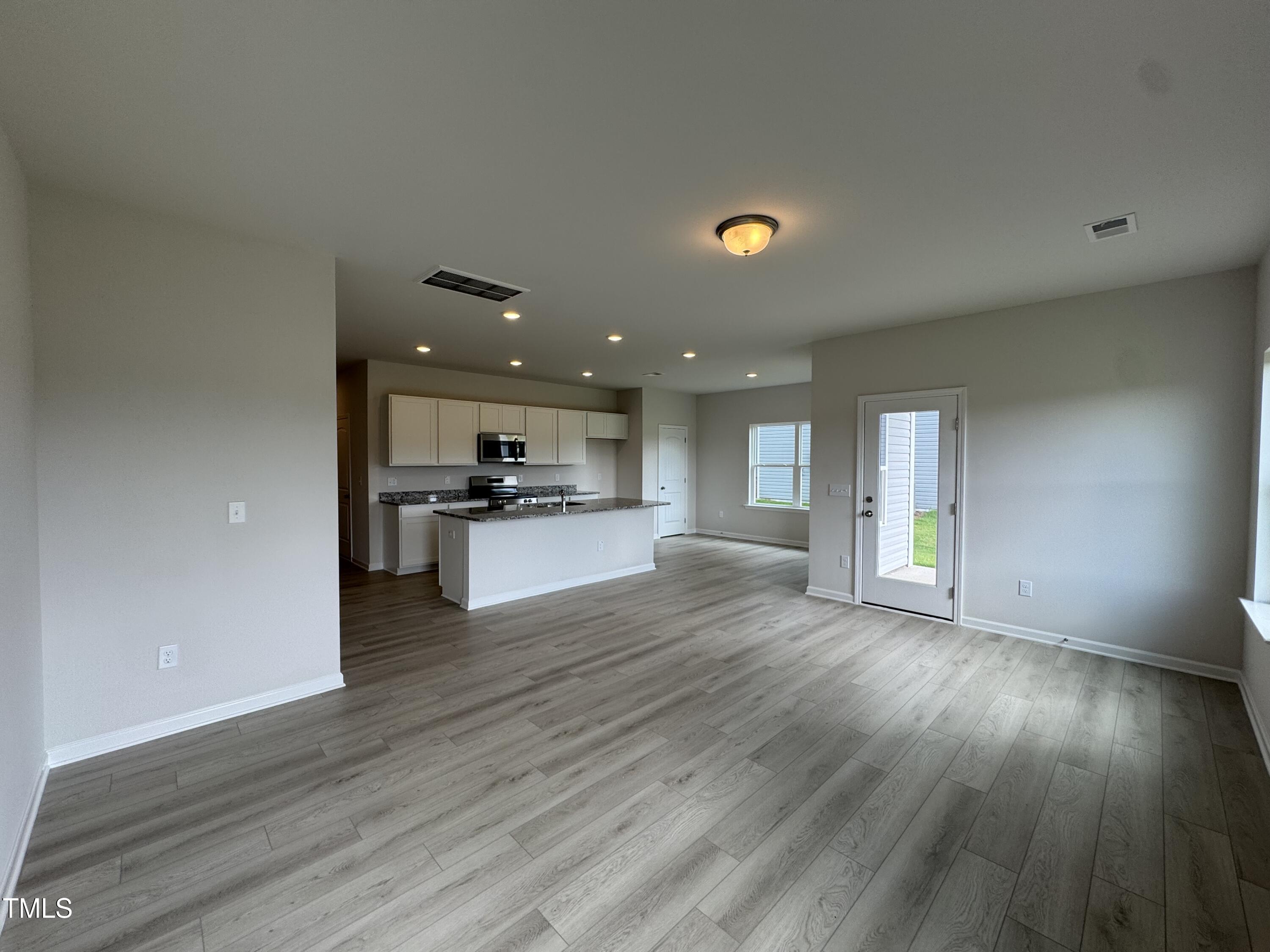 184 Bruce Drive Dunn, NC 28334 - Photo 6 of 32 a view of kitchen with cabinets and wooden floor