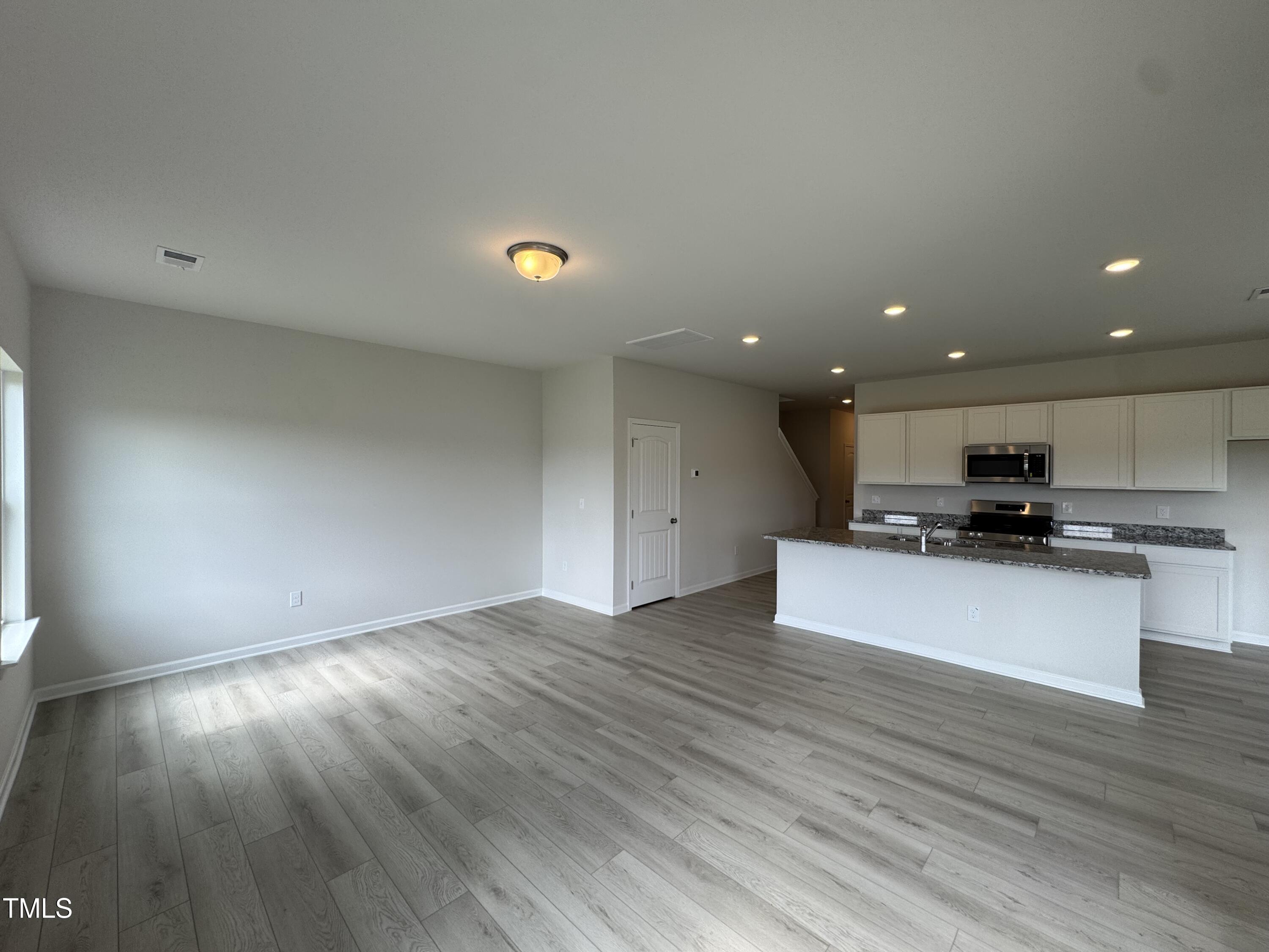 184 Bruce Drive Dunn, NC 28334 - Photo 8 of 32 a view of kitchen with kitchen island microwave and stove