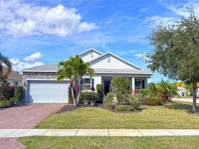 a front view of a house with a yard and garage