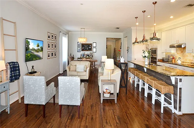 a view of a dining room with furniture and wooden floor