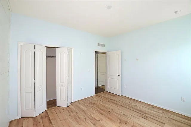 a view of a livingroom with wooden floor and closet