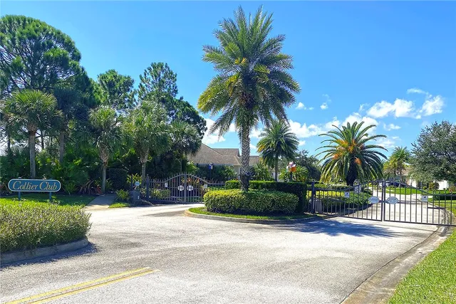 a palm tree sitting in front of a house with a garden