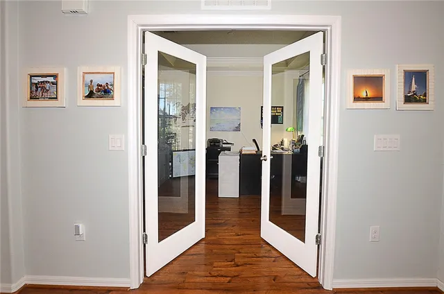 a view of a hallway with wooden floor and closet