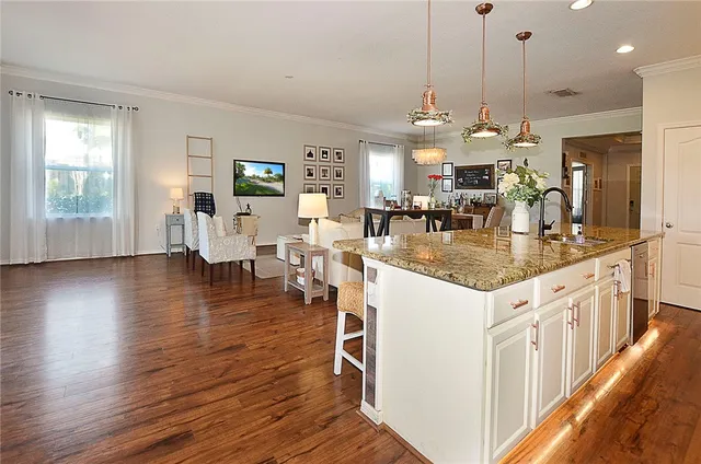 a kitchen with stainless steel appliances granite countertop a stove and a wooden floors