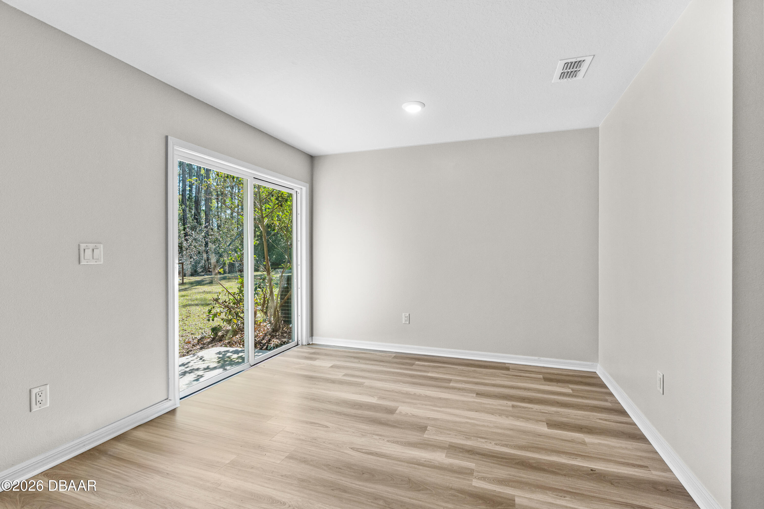 2 Union Court Palm Coast, FL 32164 - Photo 16 of 42 a view of an empty room with wooden floor and a window