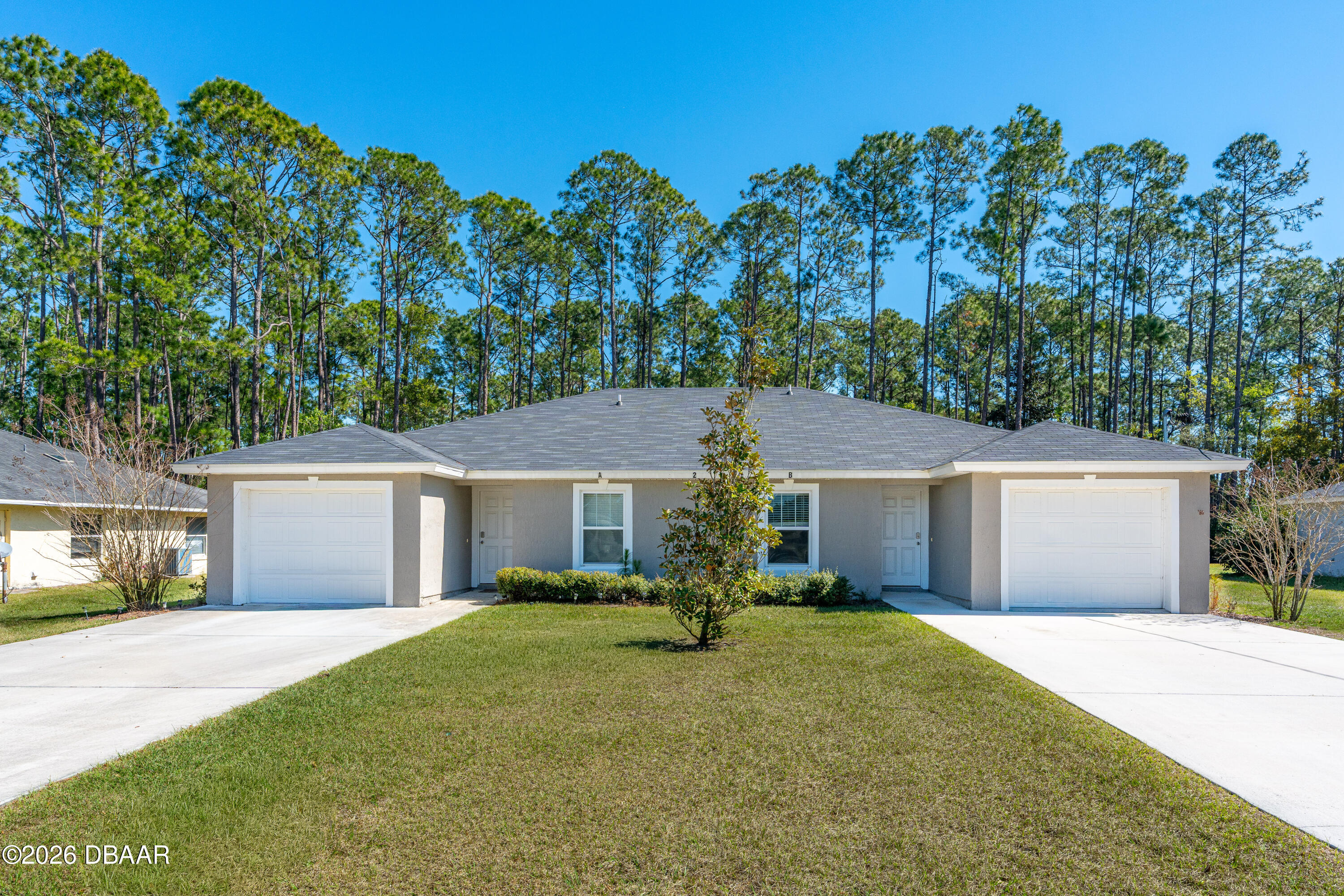 2 Union Court Palm Coast, FL 32164 - Photo 3 of 42 front view of a house and a yard