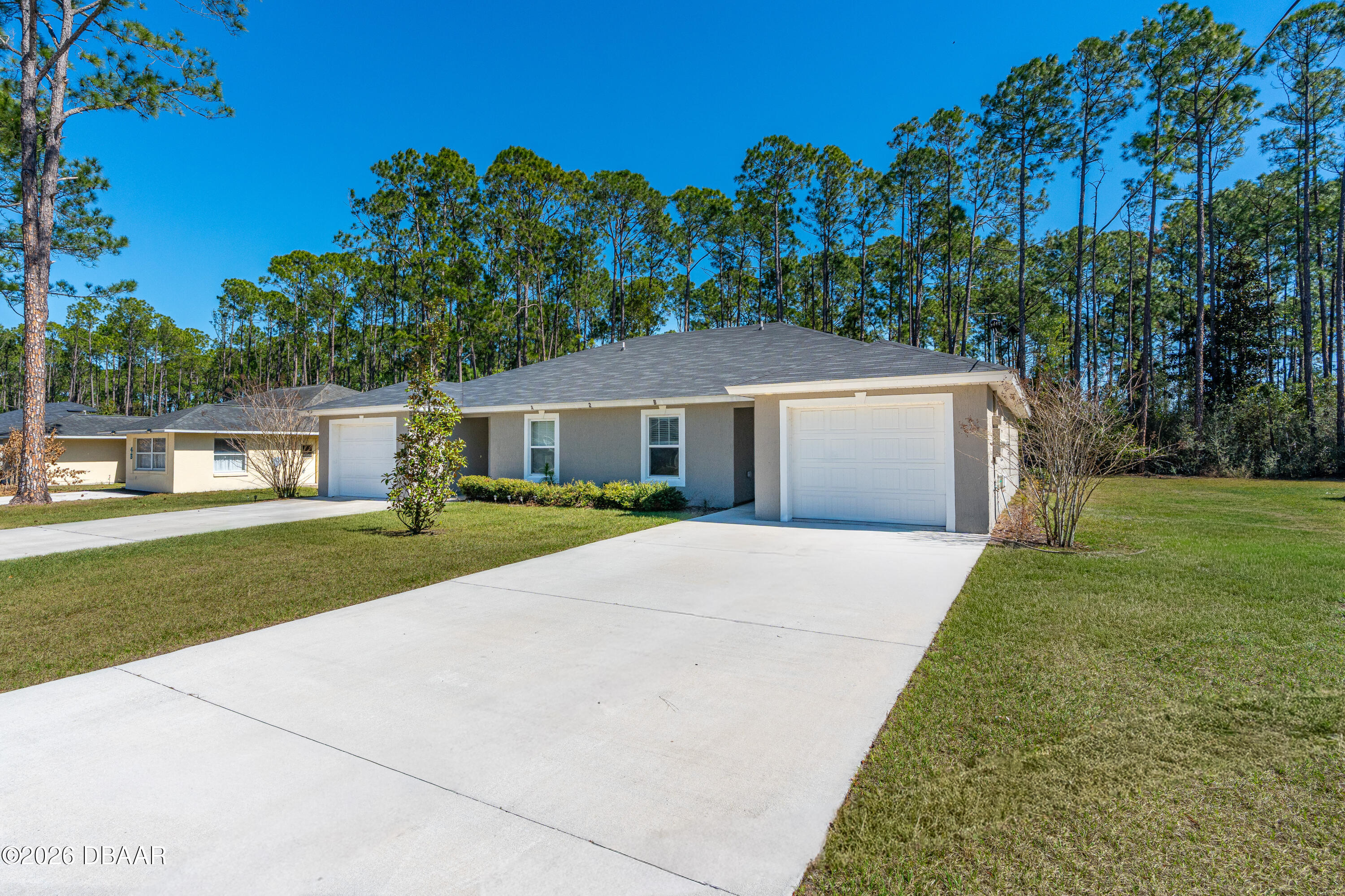 2 Union Court Palm Coast, FL 32164 - Photo 6 of 42 a front view of a house with a yard and garage