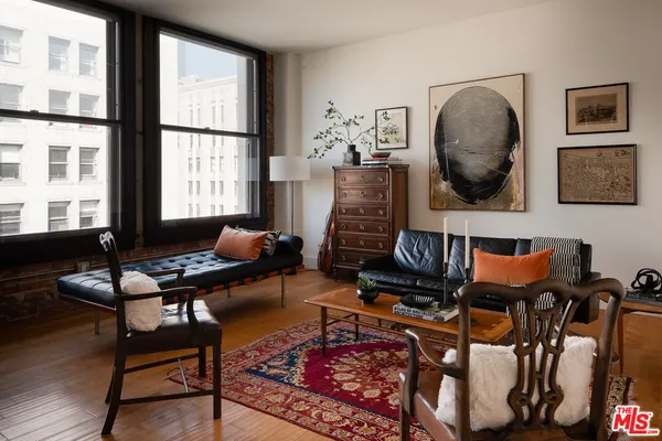a living room with furniture and a floor to ceiling window