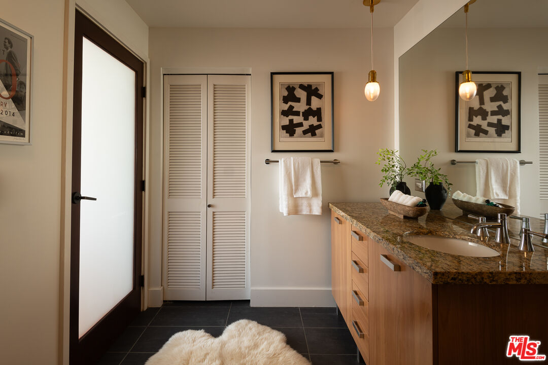 460 South Spring Street, Unit 1015 Los Angeles, CA 90013 - Photo 22 of 50 a bathroom with a sink mirror and vanity