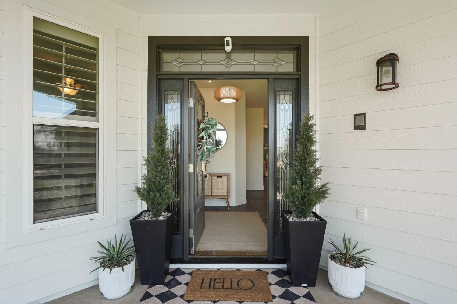 a front view of a house with potted plants