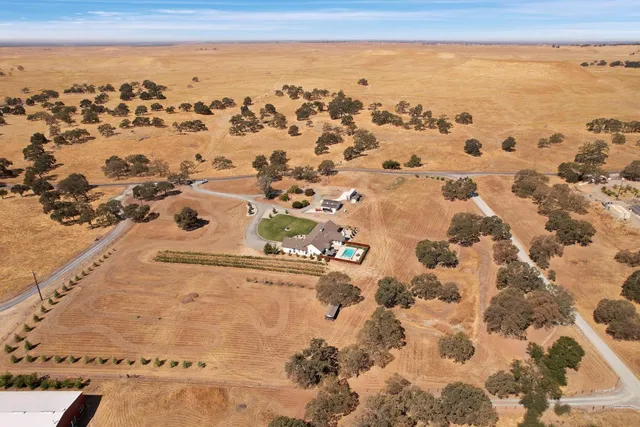 a living room with furniture a fireplace and a chandelier