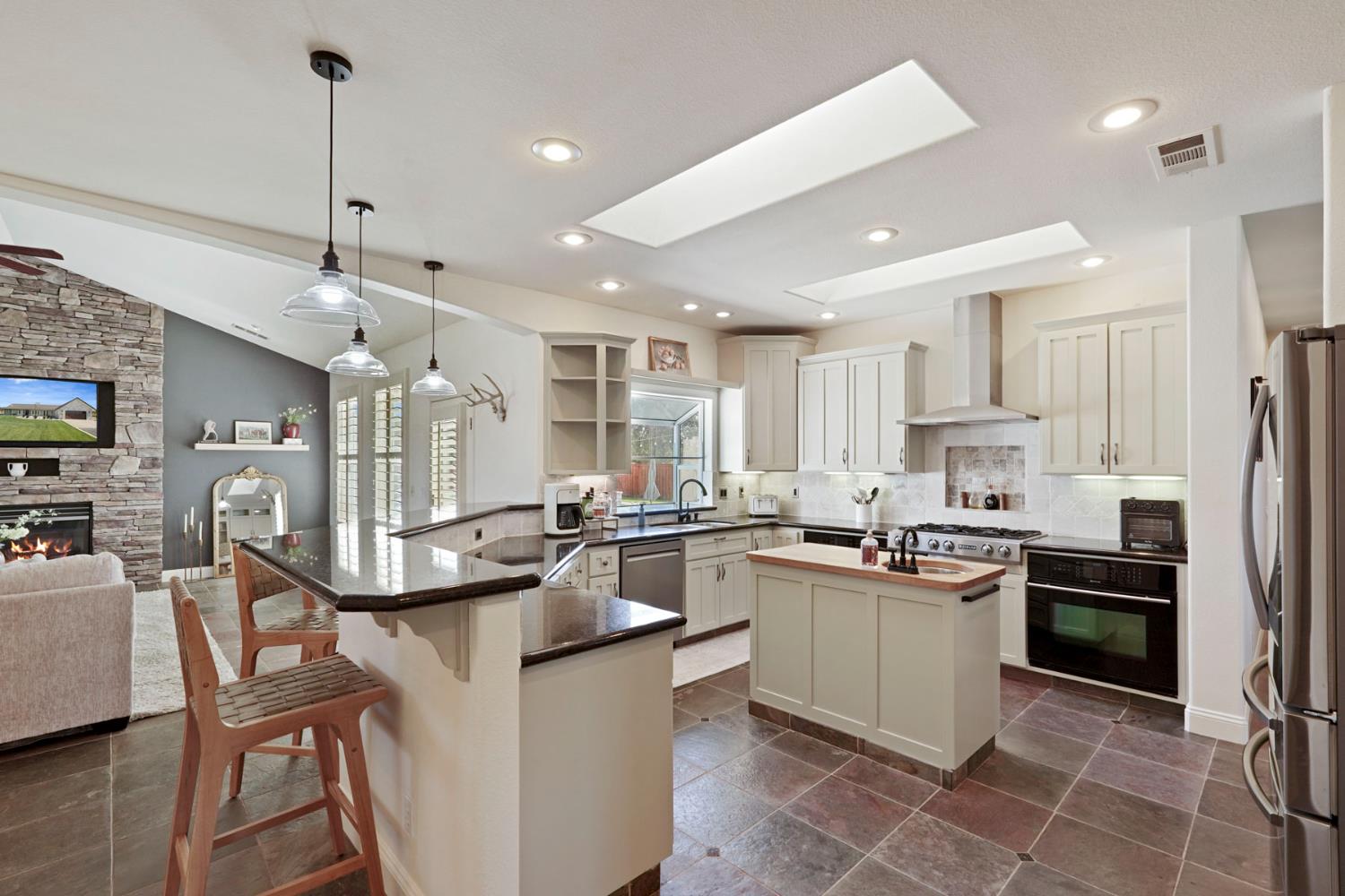 8779 Ospital Road Valley Springs, CA 95252 - Photo 22 of 80 a kitchen with stainless steel appliances kitchen island granite countertop a sink and cabinets