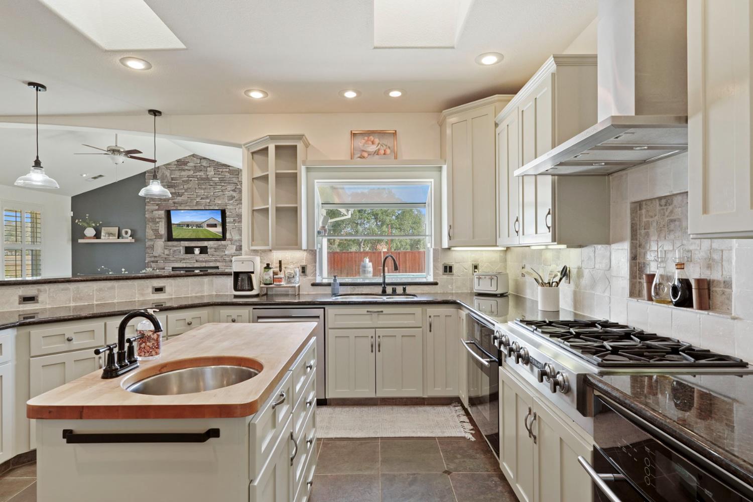 8779 Ospital Road Valley Springs, CA 95252 - Photo 23 of 80 a kitchen with stainless steel appliances a sink stove and cabinets
