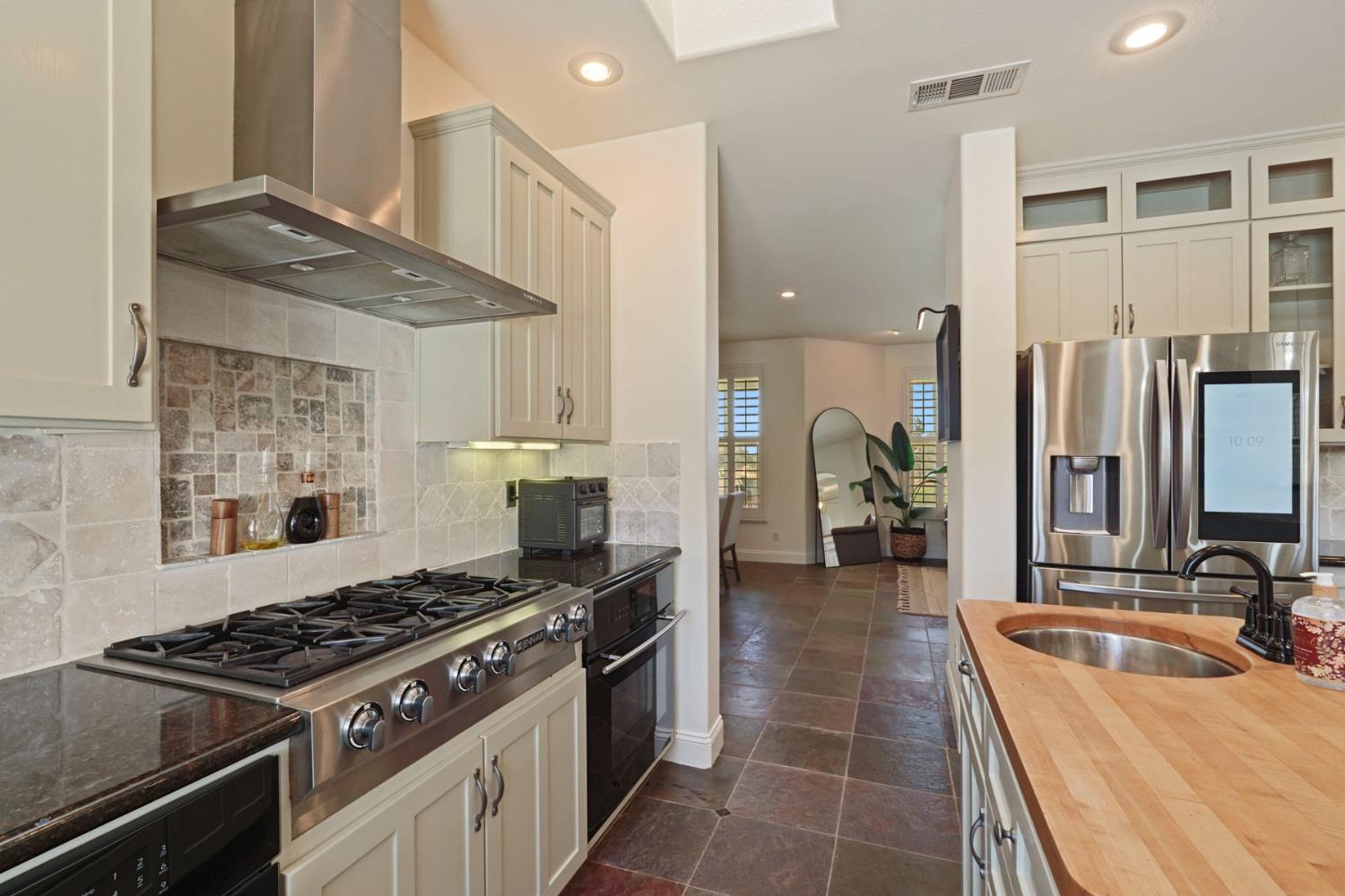 8779 Ospital Road Valley Springs, CA 95252 - Photo 25 of 80 a kitchen with stainless steel appliances a stove a sink and a refrigerator