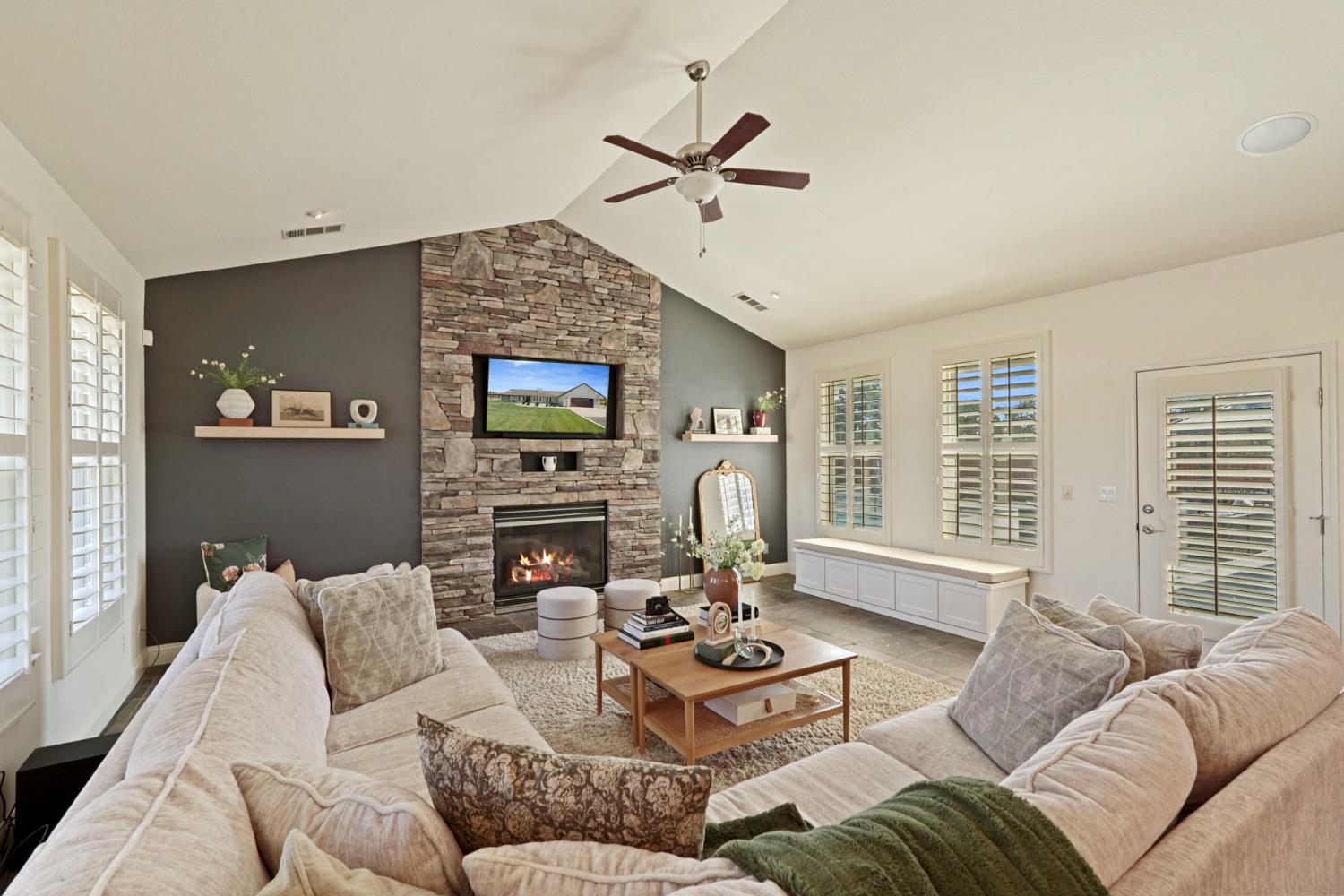 8779 Ospital Road Valley Springs, CA 95252 - Photo 28 of 80 a living room with furniture a fireplace and a flat screen tv