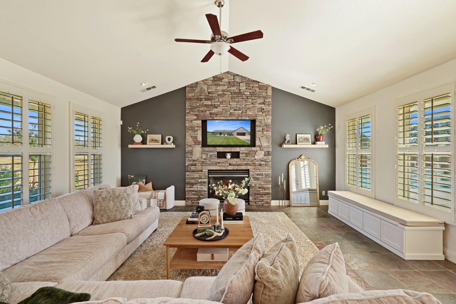 8779 Ospital Road Valley Springs, CA 95252 - Photo 29 of 80 a living room with furniture a fireplace and a chandelier