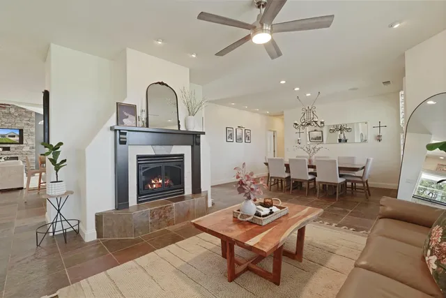 an empty room with wooden floor and a ceiling fan