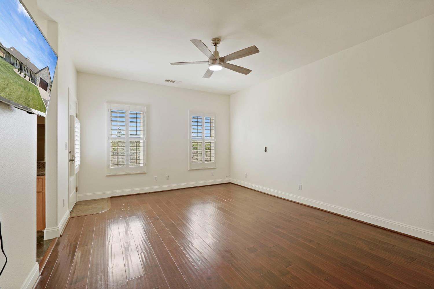 8779 Ospital Road Valley Springs, CA 95252 - Photo 46 of 80 a view of an empty room with wooden floor and a window