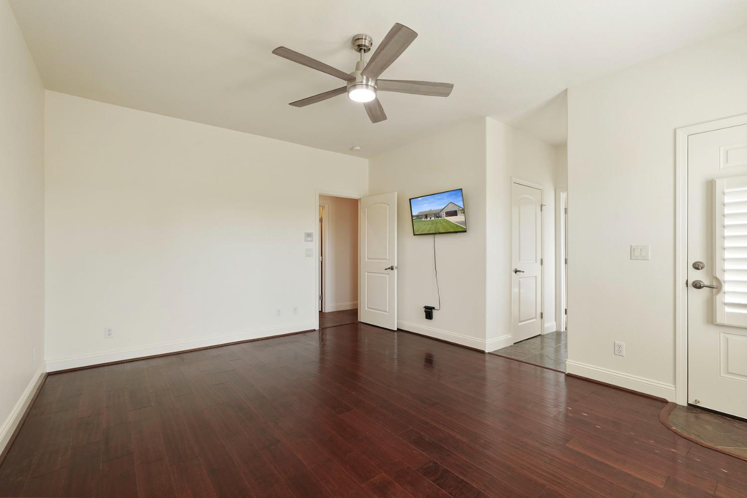 8779 Ospital Road Valley Springs, CA 95252 - Photo 47 of 80 an empty room with wooden floor and a ceiling fan