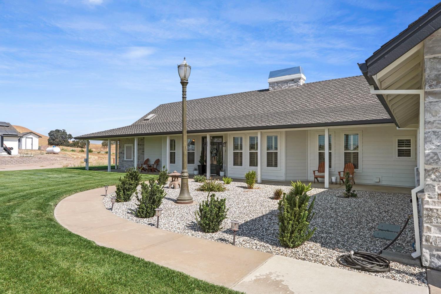 8779 Ospital Road Valley Springs, CA 95252 - Photo 61 of 80 a front view of a house with garden and porch