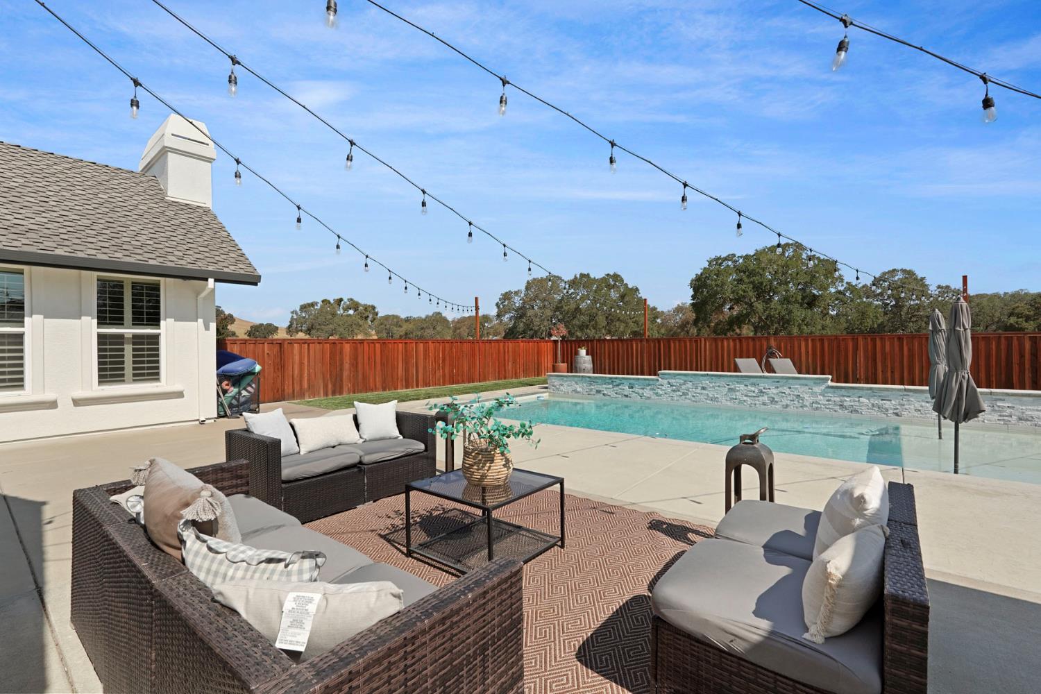 8779 Ospital Road Valley Springs, CA 95252 - Photo 69 of 80 a view of a patio with couches chairs and a fire pit