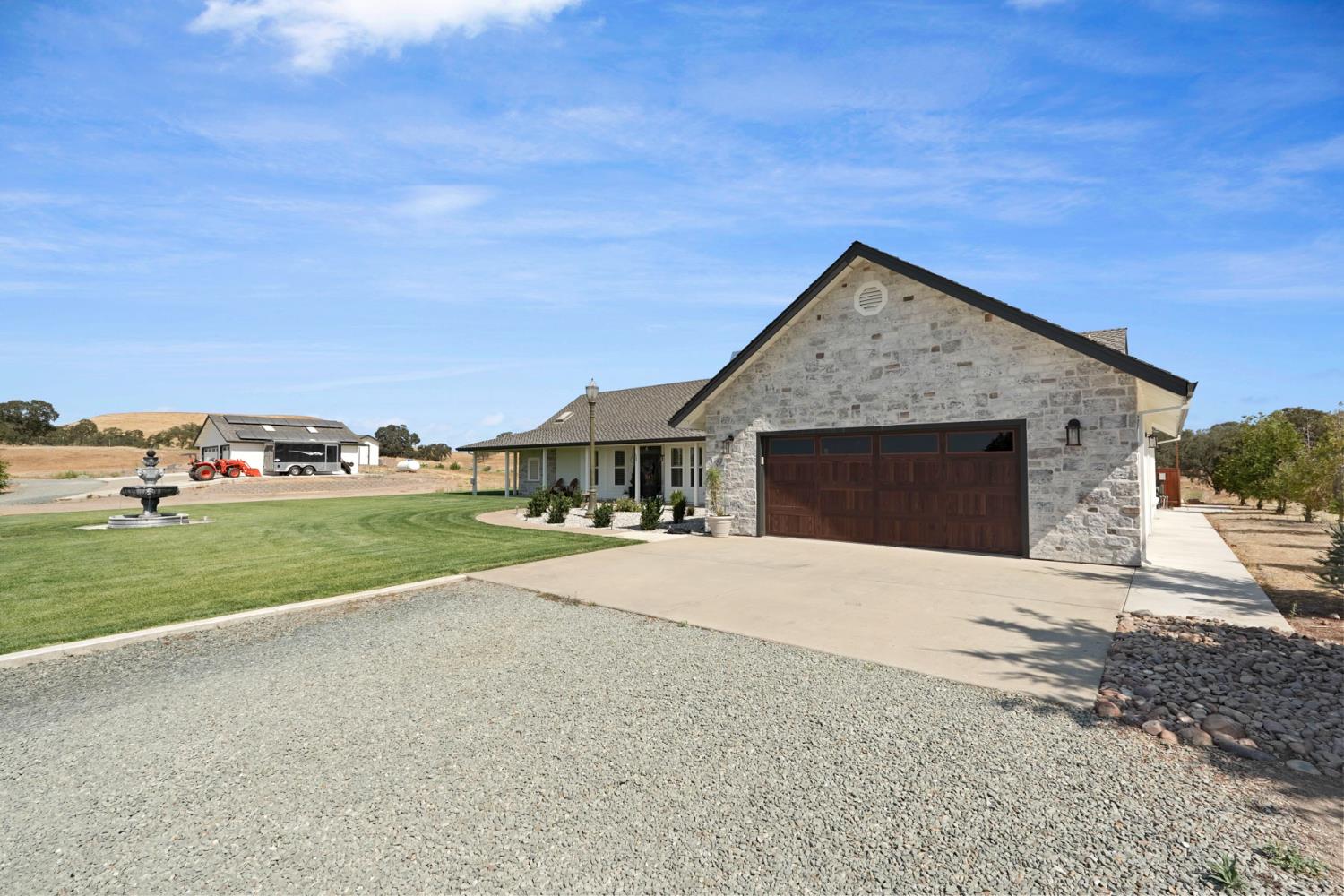 8779 Ospital Road Valley Springs, CA 95252 - Photo 77 of 80 a front view of a house with a yard and garage