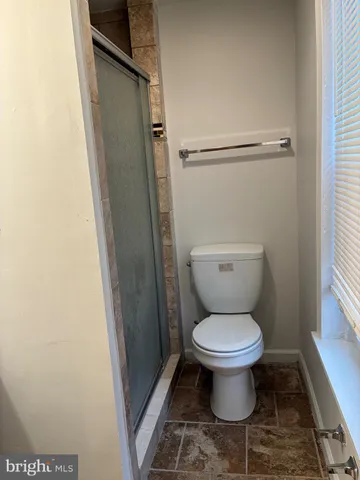 a white toilet sitting in a bathroom