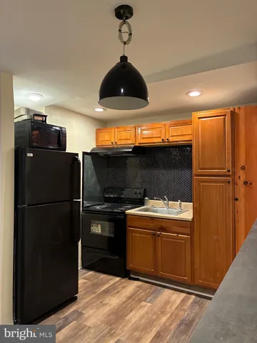 a kitchen with a refrigerator and a stove