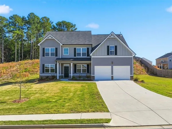 a front view of a house with a yard