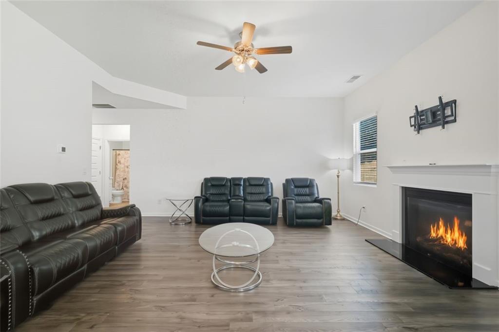 469 Ralph Still Road Dacula, GA 30019 - Photo 11 of 42 a living room with furniture and a fireplace